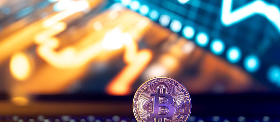 Bitcoin coin on keyboard with nice background. Crypto money concept. High quality photo